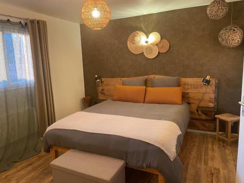 a bedroom with a large bed with orange pillows at Chez Fab in Ferrières-lès-Ray