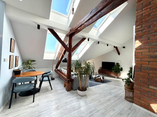 an attic living room with a table and chairs at Premium Design Loft - Old Town in Košice