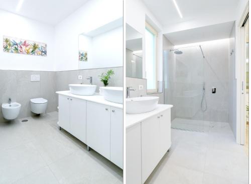 a white bathroom with two sinks and a shower at Casa Saveria in Massa Lubrense
