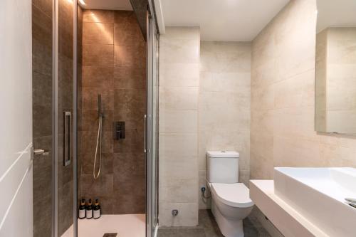 a bathroom with a shower and a toilet and a sink at UNIQUE HOMES LAS SETAS LA CAMPANA in Seville