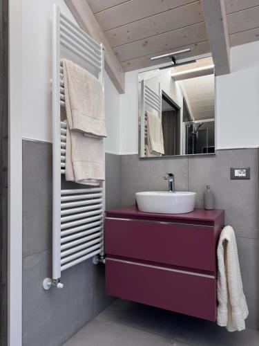 a bathroom with a sink and a mirror at Azalea Appartamenti in Cannobio