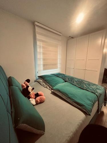 a bedroom with a bed with two stuffed animals on it at Apartment klein, fein, ruhig und gemütlich in Bochum