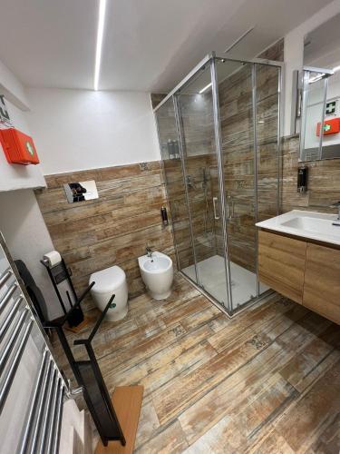 a bathroom with a shower and a toilet and a sink at Mini Suite Apartment 2 in Castel di Sangro