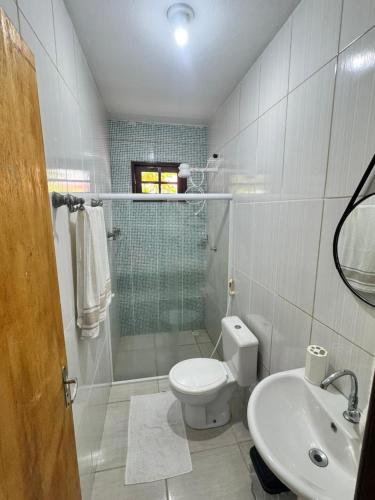 a bathroom with a toilet and a sink at Beach House Sao Jose in São José da Coroa Grande