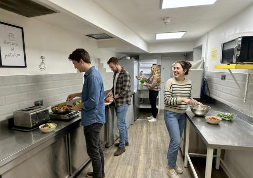 a group of people in a kitchen preparing food at Smart Hyde Park View in London