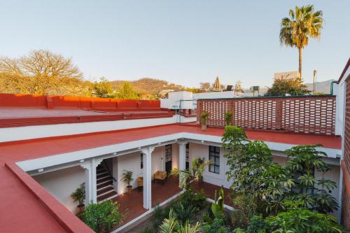 anterior view of a building with plants and trees at Cocoon Oaxaca City- Curated Stay In Oaxaca Centro in Oaxaca City