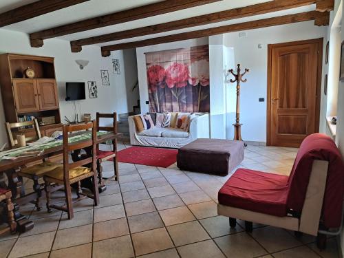 a living room with a table and a couch at Passione Peonie Apartment in Roccabruna