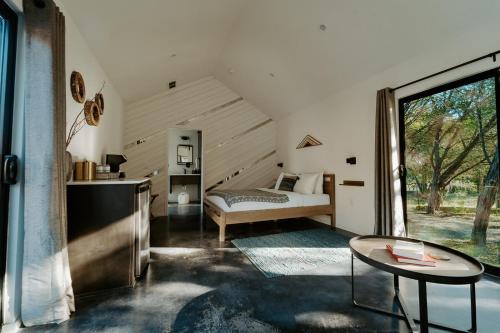 a bedroom with a bed and a table at Lucky Arrow Retreat in Dripping Springs