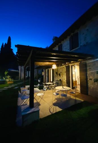 a patio with a table and chairs at night at Ca Malfer in Costermano sul garda
