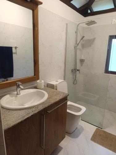 a bathroom with a sink and a toilet and a shower at Golden Leaf house in Weligama
