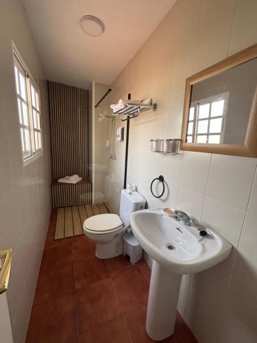 a bathroom with a white sink and a toilet at Torkes in Foz