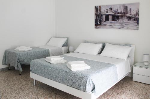 a bedroom with two beds and a picture on the wall at Felicia in Bisceglie