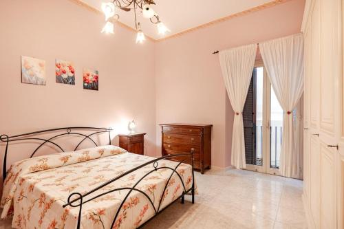 a bedroom with a bed and a dresser and a window at Residenza Torre Antica - Nel Cuore di Viterbo in Viterbo