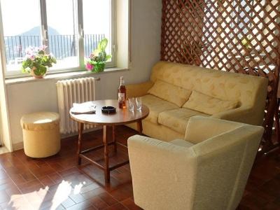 a living room with a couch and a table at Hotel Panorama di Sicilia in Castelmola
