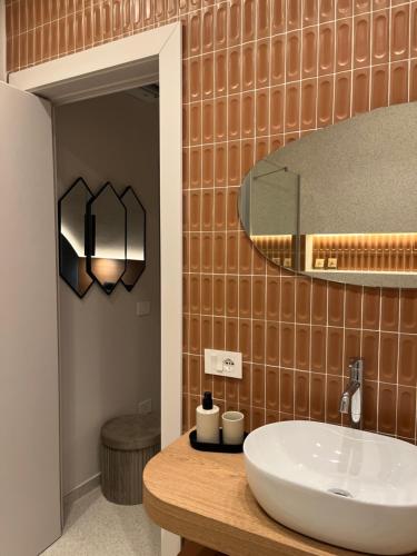 a bathroom with a sink and a mirror at Angilè Rooms in Agrigento