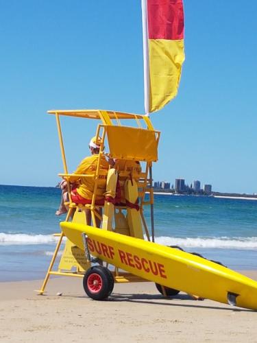a yellow plane on the beach with a life preserve sign at Verve on Cotton Tree in Maroochydore