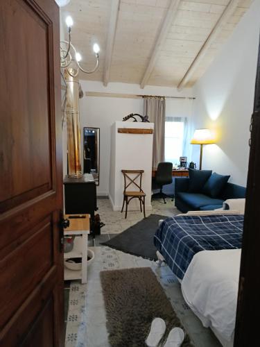 a bedroom with a bed and a living room at Αγρόκτημα Agrikia Σπίτι in Arachova