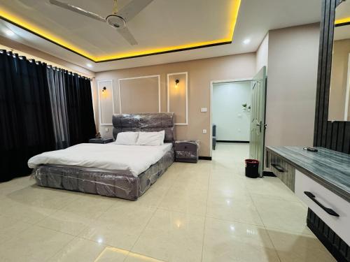 a bedroom with a large bed in a room at Stay Homie - 1BHK, Near ISB Airport, Self Check-In, Secure in Islamabad