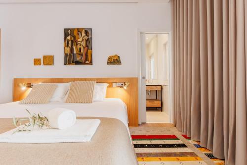 a hotel room with two beds and curtains at Laranjal Rive Gauche in Tavira