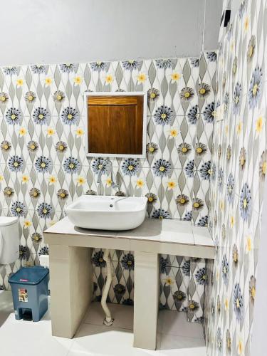 a bathroom with a sink and a mirror at Mama Homestay in Kuta Lombok