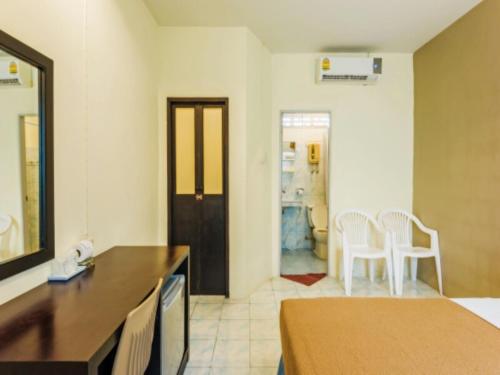 a living room with a table and chairs in a room at Baantonsai Garden Resort in Patong Beach