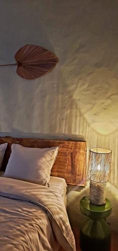 a bedroom with a bed and a lamp on a table at A Toca, Complete townhouse apartment in Monchique