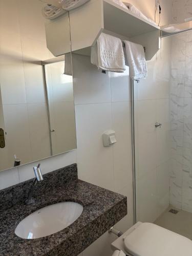 a bathroom with a sink and a toilet at Studio J&C in Primavera do Leste