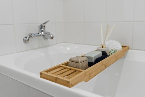 a bathroom sink with a faucet and a tray of soap at Clay Cottage in Waimauku