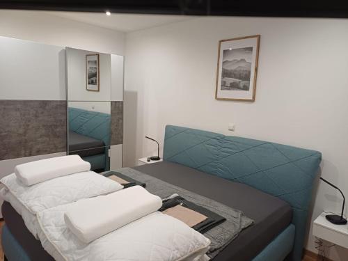 a bedroom with two beds and a mirror at Ferienapartment "Zur Linde" in Breitenstein
