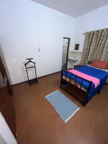 a bedroom with a bed and a desk in it at Tourist Rendez Vous Hotel in Plaine Magnien