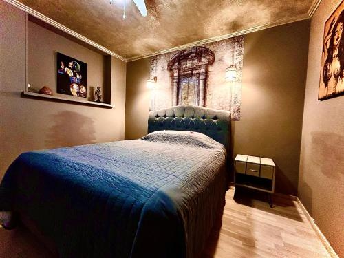 a bedroom with a blue bed with a window at Traditional Narva House in Narva
