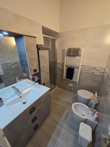 a large bathroom with a sink and a toilet at marinella house 2 in Sarzana