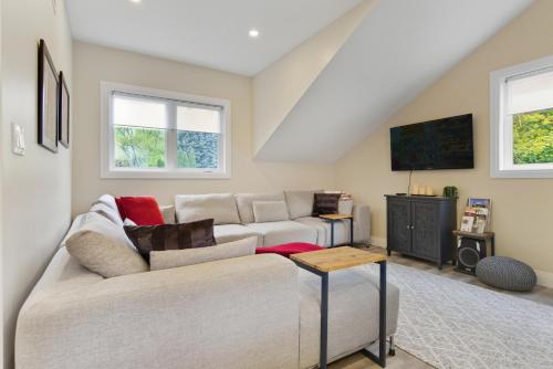 a living room with a couch and a tv at Redwood Suite in Niagara on the Lake