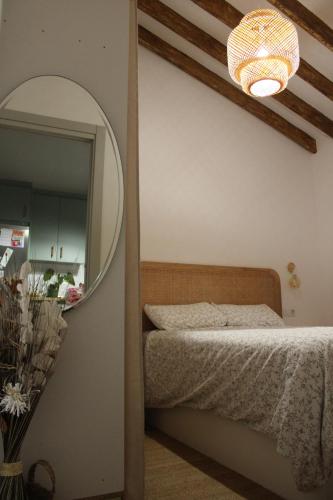 a bedroom with a bed and a mirror at Casa Calera in Nerja