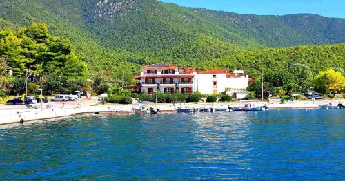 a large body of water with a building in the background at Anna Maria - Vanessa Apartments in Neo Klima