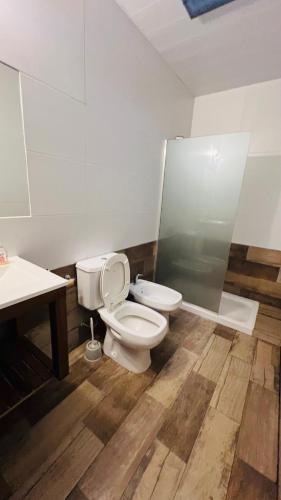 a bathroom with a toilet and a sink at Coty A in Saladillo