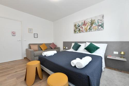 a bedroom with a bed and a couch at Mondeo B&B in Udine