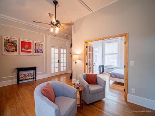 a living room with a couch and chairs and a mirror at Oak and Ember at Marietta Square in Marietta