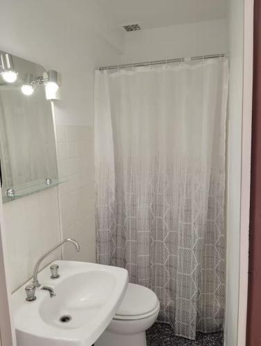 a bathroom with a sink and a toilet and a shower at Chambre La Charolaise in Aubessagne