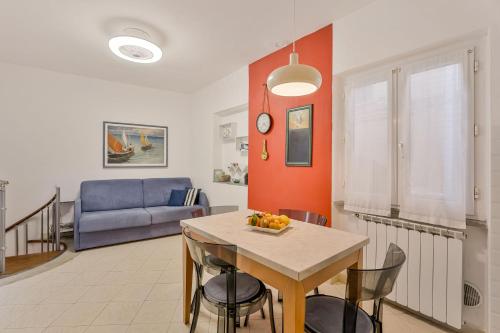 a living room with a table and a blue couch at Sea Whisper Volastra in Volastra