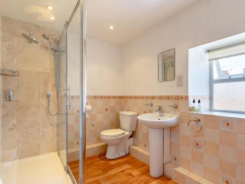 a bathroom with a toilet and a sink and a shower at 2 Bed in Holt oc-ncc66 in Blakeney