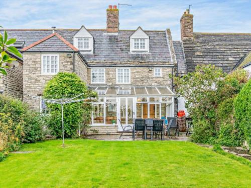 an exterior view of a house with a yard at 4 Bed in Wareham oc-dc125 in Corfe Castle