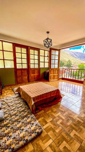 a bedroom with a bed in a room with a view at Aqui y Ahora in Pisac