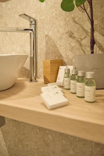 a wooden counter with four bottles of medicine on it at Room45 in Marzamemi