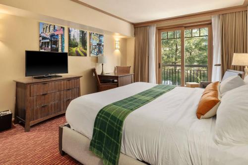 a bedroom with a large bed and a television at 2038 Warm Winter Retreat - Perfect Lodge Room in Cle Elum