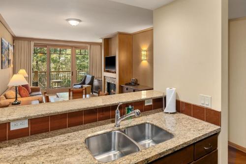 a kitchen with a sink and a living room at 2038 Warm Winter Retreat - Perfect Lodge Room in Cle Elum