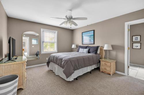 a bedroom with a bed and a ceiling fan at 221 Olive Way in Saint Simons Island