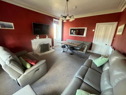 a living room with a couch and a table at Period House Auldcastle Road Crown in Inverness