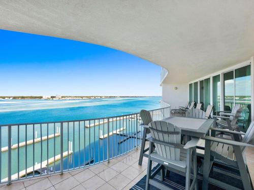 a balcony with a table and chairs and the ocean at Caribe The Resort #C702 in Perdido Key