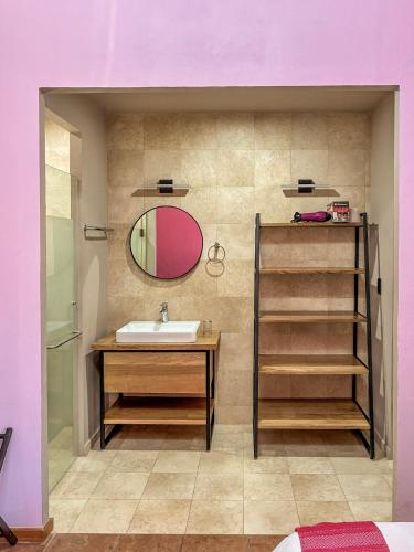 a bathroom with a sink and a mirror at Suites Patio Antequera in Oaxaca City